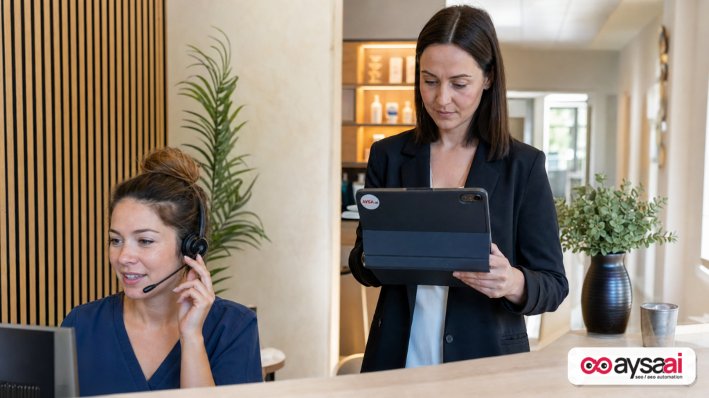 Clinic receptionist handling a call while a manager reviews an appointment calendar.